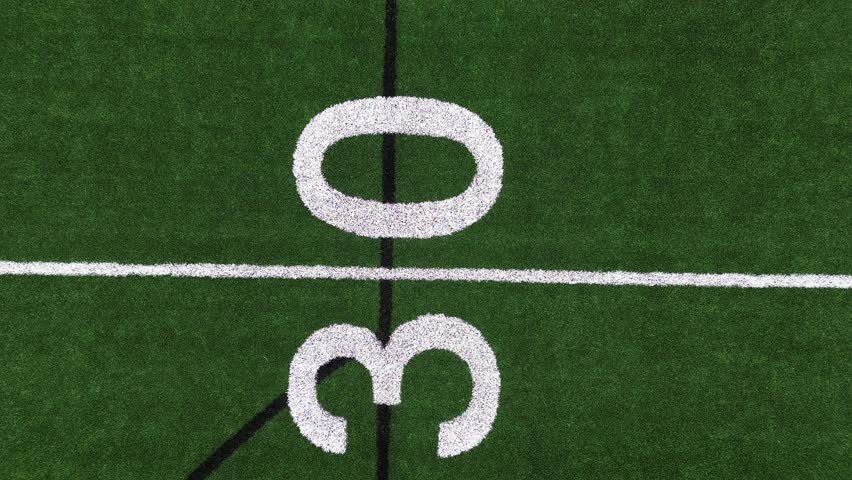 Pan Down and Rocket View of Turf Football Field from the Fifty Yard Line Royalty-Free Stock Footage #3487441493