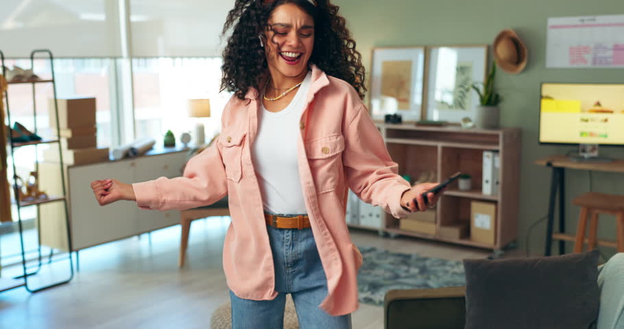 Happy, black woman and dancing with music on smartphone for celebration, relax and freedom at home. Excited, female person and mobile for streaming podcast or listening to audio on sofa or couch
