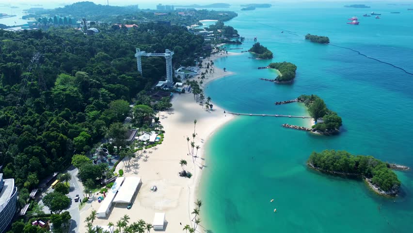 Aerial drone landscape of Sentosa Island Siloso harbour beachfront cable car sandy ocean bungee jump Singapore recreation Asia travel tourism