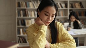 Boring student asian girl feeling tired during study at university library Stressed young woman exhausted from remote distance work or education hard program indoors - Powered by Shutterstock - Get 15% off with code: PIKWIZARD15