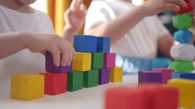 children toddler group playing with blocks. development fine motor sunset skills kindergarten concept. children brother sister group playing cubes table near window. children playing with blocks - Powered by Shutterstock - Get 15% off with code: PIKWIZARD15