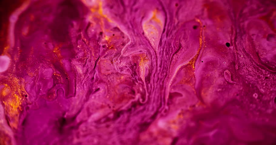Sparkling paint flow. Alcohol ink spill. Wet glitter texture. Defocused pink red orange color golden metallic shiny dust sequin particles water fluid drip motion abstract art background.