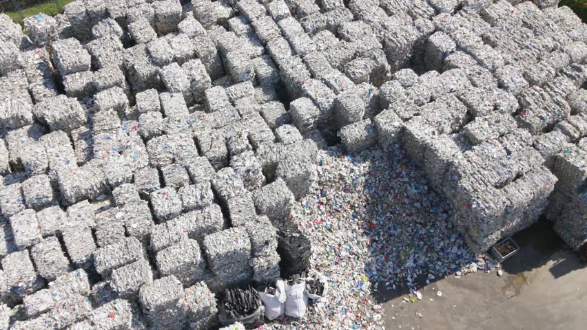 Aerial view overlooking large garbage cubes, sunny day at a junkyard