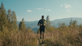 Sportive fit strong healthy Caucasian male sportsman man runner athlete jogging running mountain trail trainer run morning endurance cardio workout sport climb hiking outdoors mountainside hill nature - Powered by Shutterstock - Get 15% off with code: PIKWIZARD15