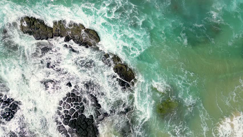 Looking down at the rocks next to Cudgen Creek at Kingscliff in New South Wales in Australia. Royalty-Free Stock Footage #3488003571