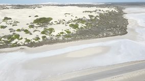 Drone aerial over pink lake Macdonnell and sand dunes in South Australia