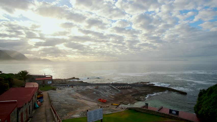 Scenic sunrise over Walker Bay with view over historic Old Harbour of Hermanus Royalty-Free Stock Footage #3488056131