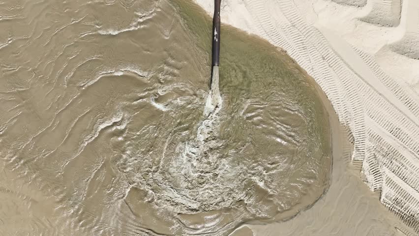 Direct aerial view with drone of a dredging beach process. Royalty-Free Stock Footage #3488060247