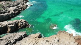 Mysterious emerald green sea and rugged rocks