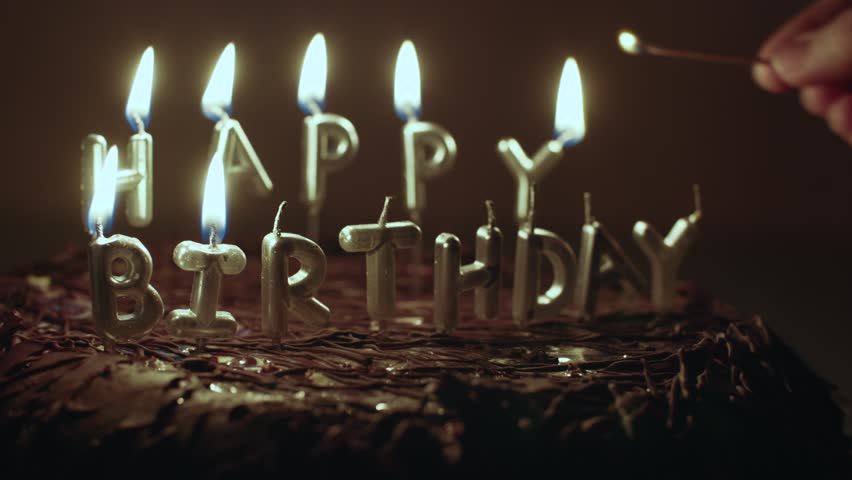 candle lighting on a chocolate birthday cake