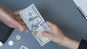 Person receiving big pile of american dollars banknotes. Tax evasion and corruption concept. Transfer money from hand to hand. Woman giving cash money to man. Vertical video - Powered by Shutterstock - Get 15% off with code: PIKWIZARD15