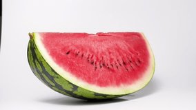 White background 4K slow motion video of cutting watermelon.