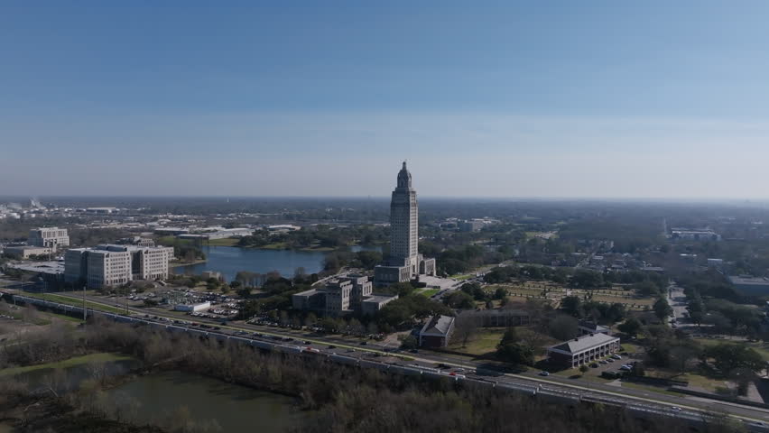 Wide aerial footage of the capitol building in downtown Baton Rouge in the morning.
