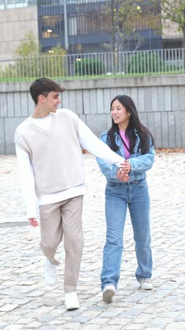 A playful young couple share a joyous moment with a piggyback ride, laughter echoing as they engage in this carefree, fun-loving activity outdoors.