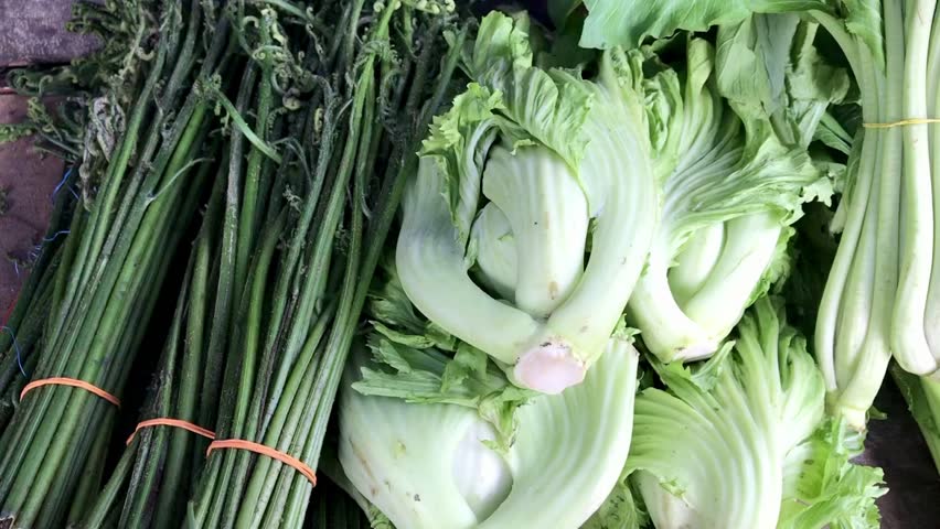 Various ripe organic vegetables at Farmers Market. Javanese traditional market. Green mustard, onion leaves, Chinese cabbage, white cabbage, Bok choy, celery. Sell green healthy vegetables in grocery, Royalty-Free Stock Footage #3488419375