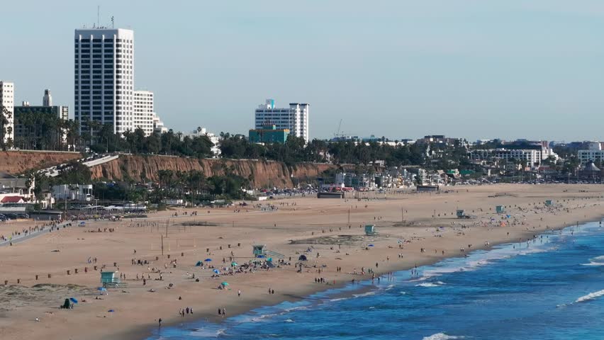 Aerial drone shot showing the very busy Santa Monica Beach on a nice day