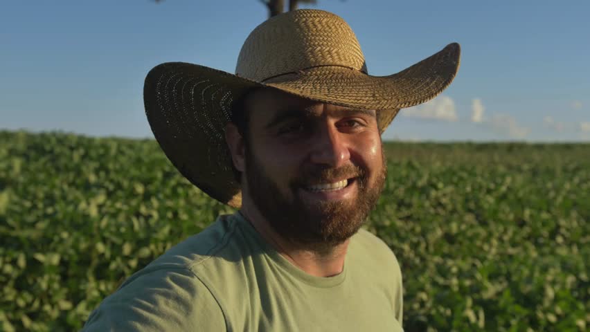 close up footage of a soybean farmer man with a country hat on a soybean plantation - countryside of Brazil