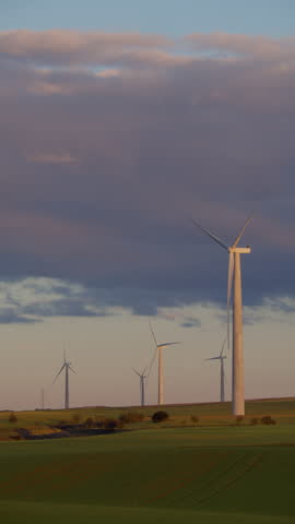Vertical video of wind turbines landscape at sunset