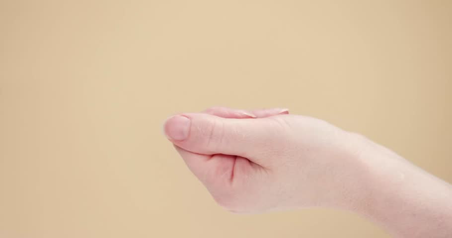 female hand on a beige background, open palm
