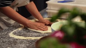 professional chef preparing pizza dough, shaping the dough. High quality 4k footage
