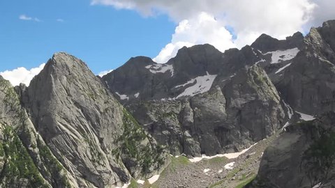time lapse:  big white clouds and steep granite walls in Valmasino, Alps, Lombardy, Italy.