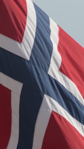 Norwegian flag waving in a beach. 4K Vertical