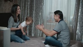 Asian couple with a little baby on their hands, happy family moments, slow motion