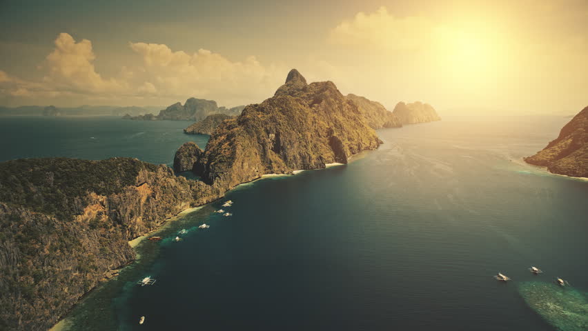 Sunset at tropical island El Nido at blue ocean bay. Sun shine aerial view. Nobody wild nature scenery at amazing tropic mountains islet of Palawan, Philippines archipelago. Cinematic summer vacation Royalty-Free Stock Footage #3488699955