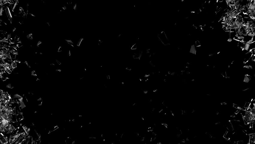 Flying glass shards. Glass breaking. Broken glass shard. Broken glass on a black background.