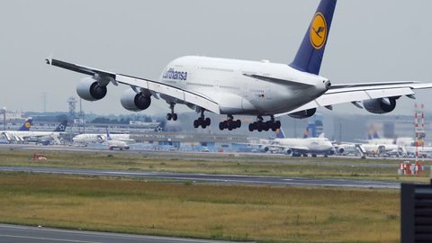 FRANKFURT AM MAIN, GERMANY - JULY 21, 2017: Rear view of Lufthansa Airbus A380-800 lands on at Frankfurt am Main airport. Airbus A340 taxiing at foreground.