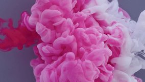 Pink and white acrylic paint splash each other in water against a blue background, colored ink spreads and bursts like a colorful cloud, fluorescent lighting and natural glitter. 4K. - Powered by Shutterstock - Get 15% off with code: PIKWIZARD15