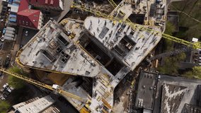 Aerial Flight Over a New Constructions Development Site in Vilnius, Lithuania. Urban Construction Site, Aerial View. High crane works on building site. Crane and building construction site. - Powered by Shutterstock - Get 15% off with code: PIKWIZARD15
