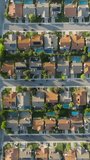Vertical video. Beautiful green suburb aerial at scenic sunset 4K Agoura Hills. Aerial drone shot of residential Calabasas suburban housing district area in USA. American homes in quiet neighborhood