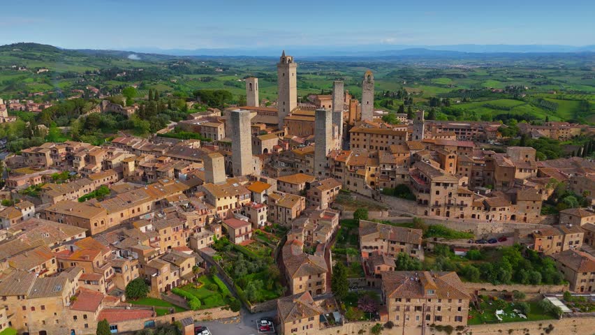 Fly around old town of San Gimignano, Tuscany, Italy. Aerial shot, old stone houses and tower in San Gimignano, Unesco World Heritage Site