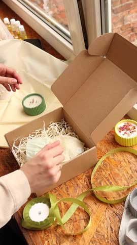 Woman hands packing and closing the craft box. Shop owner working in home office and preparing package for customer delivery