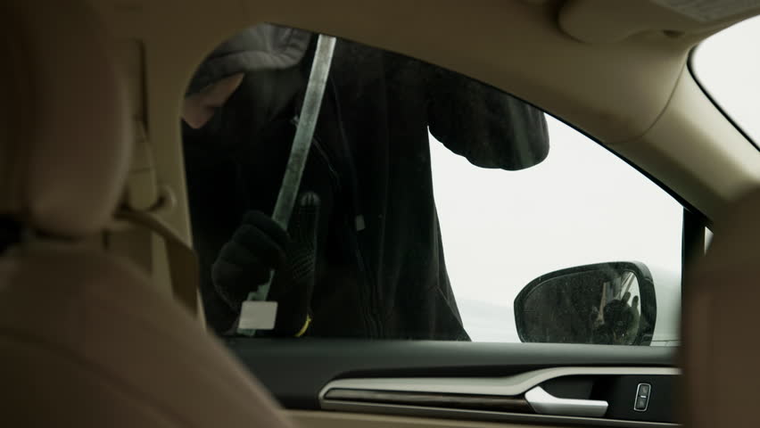 Skilled hacker infiltrates parked car swiftly bypassing security measures. Vehicle is compromised setting off alarms in city's law enforcement Stolen car vanishes into night by carjacker.