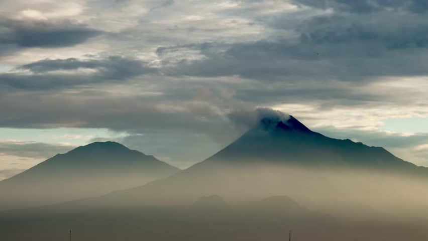 Aerial view of Mount Merapi and Merbabu with sunlight view in the morning in Yogyakarta, Indonesian volcano. beautiful morning vibes. blurred concept