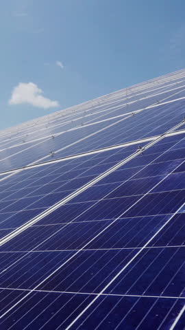 Photovoltaic solar panels at a power plant. Alternative energy production on the roof of the house. Vertical video.