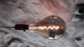 Edison lamps. Vintage light bulb pulsing light in modern house. Burning retro light bulbs hanging from ceiling. Vertical video.  - Powered by Shutterstock - Get 15% off with code: PIKWIZARD15
