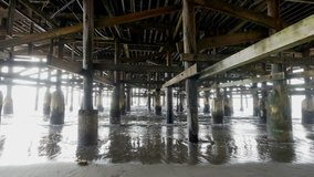 High quality video of walking under pier in 4K 

