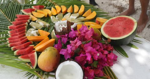 Fruit arrangement - tahiti fruit table with coconut mango watermelon melons etc. Typical local tahitian food presentation from French Polynesia.