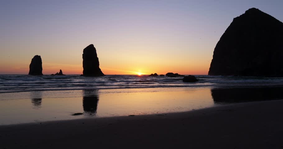 Haystack Rock at Cannon Beach, Oregon sunset in 4K. With reflections of Haystack Rock. Royalty-Free Stock Footage #3489389197