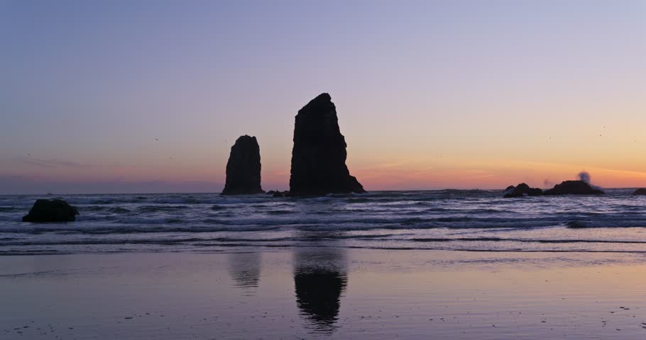 Haystack Rock at Cannon Beach, Oregon sunset in 4K. With reflections of Haystack Rock. Royalty-Free Stock Footage #3489389371