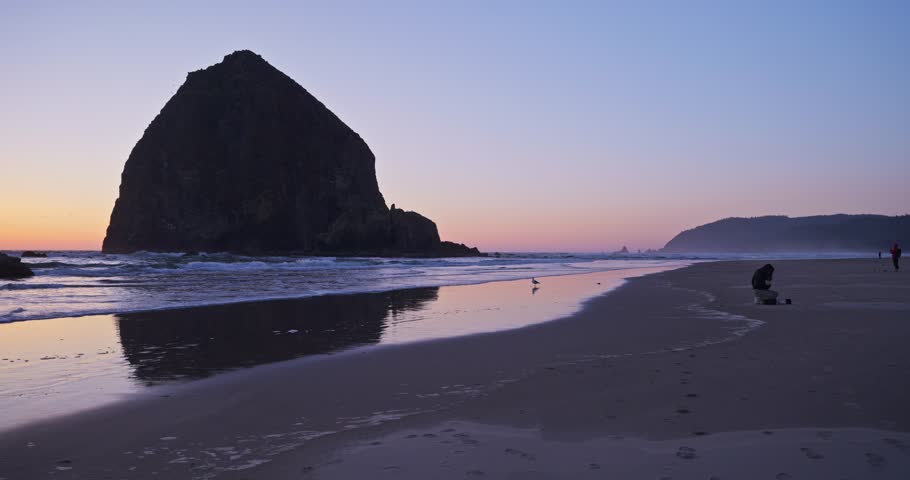 Haystack Rock at Cannon Beach, Oregon sunset in 4K. With reflections of Haystack Rock. Royalty-Free Stock Footage #3489389419