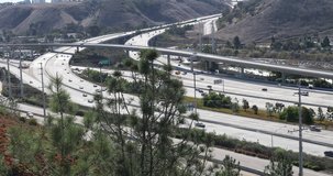Slow motion clip of two major southern California freeways running north and south on bright sunny weekend day. Shot was taken from a balcony above with a Canon 1dx mark II at 4K 60p DCI.