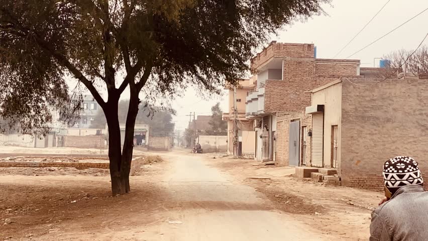 a man on bike in village road