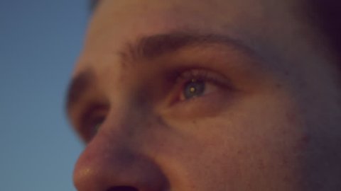 Handsome young white man eyes staring out at windy sunrise sunset freckles 