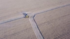 Harvester on the field during harvesting. Industrial video of agriculture