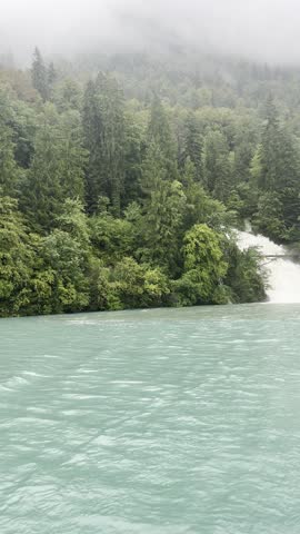 Crystal-clear waterfalls descending into the pristine embrace of Lake Brienz. Giessbach Falls. Interlaken. Switzerland.