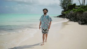 Happy man with a full beard and curly hair is wading through the shallow clear waters of a tropical beach, smiling as he enjoys the warm ocean breeze - Powered by Shutterstock - Get 15% off with code: PIKWIZARD15